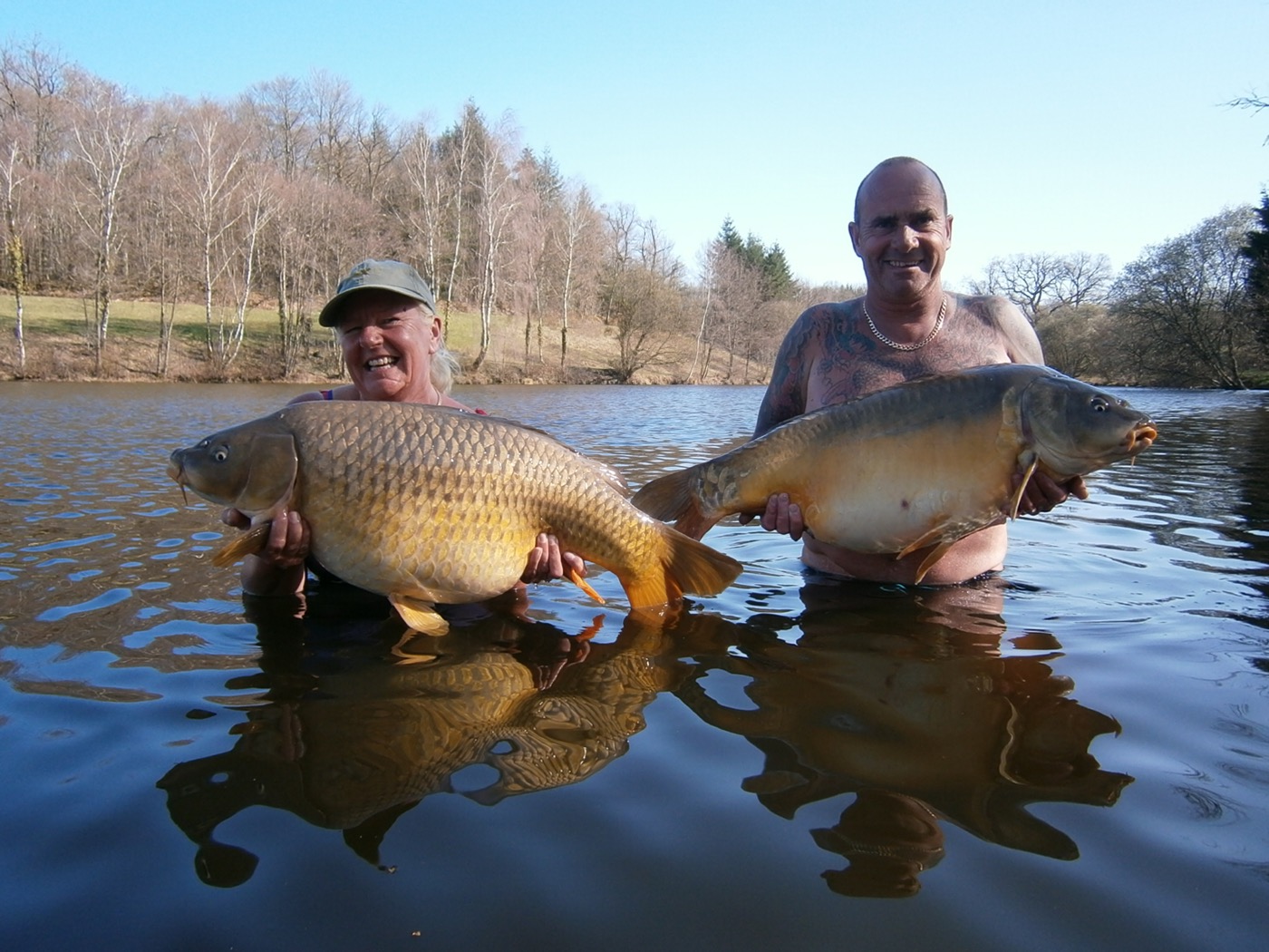 Two anglers holding large carp at Lodge Lakes