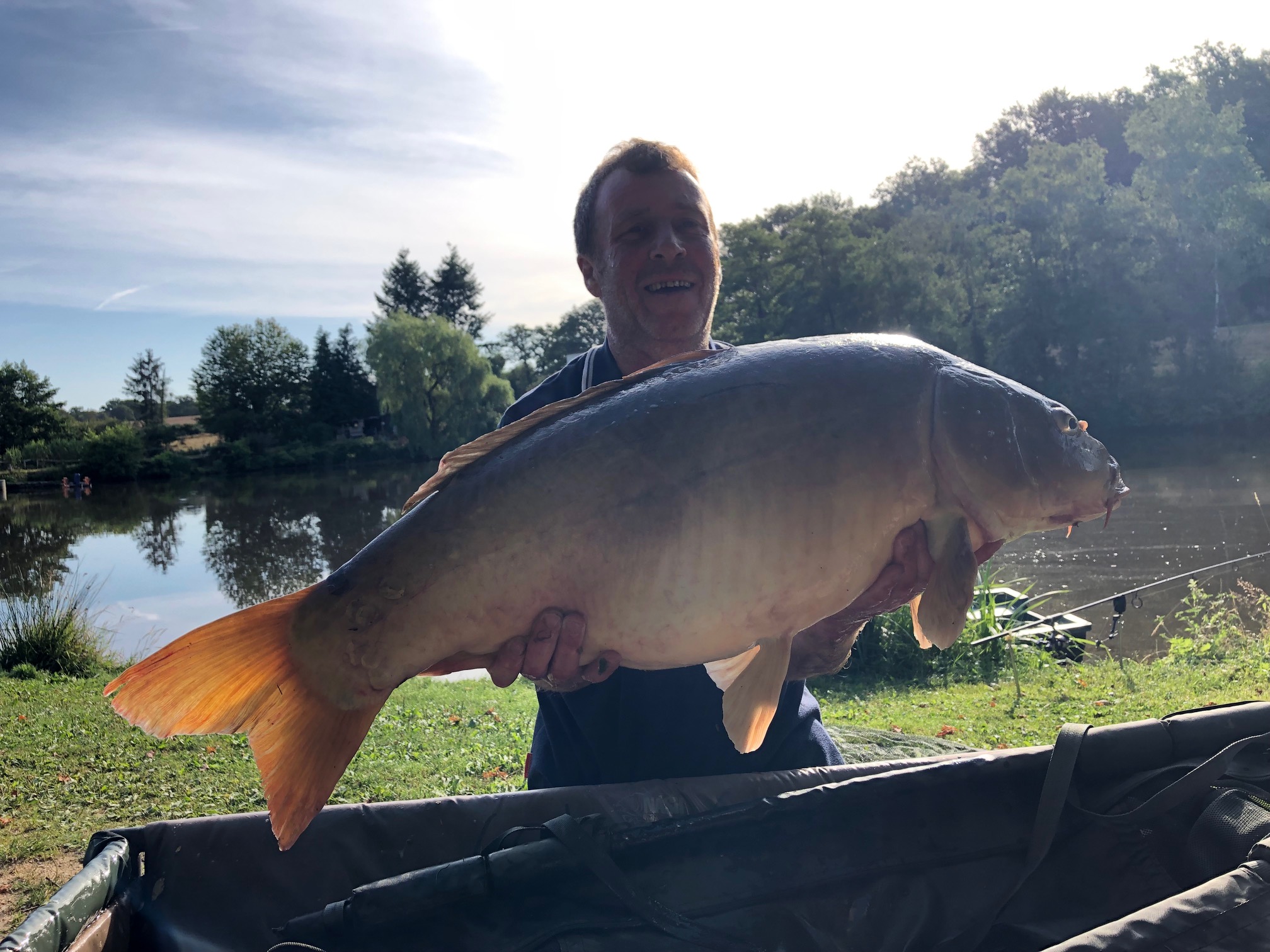Carp held in the water at The Lodge Lake